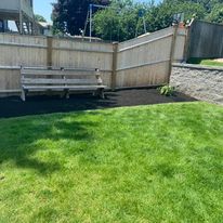 Wood privacy fence with a bench