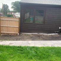 Wood privacy fence beside a shed