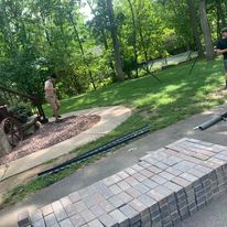 Paver walkway edged with lawn
