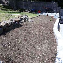 Fieldstone wall with a freshly graded bed