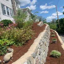 Fieldstone wall with a planted garden bed