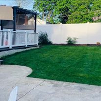 New lawn beside a patio and porch