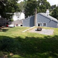 Gravel fire pit pad in a side yard